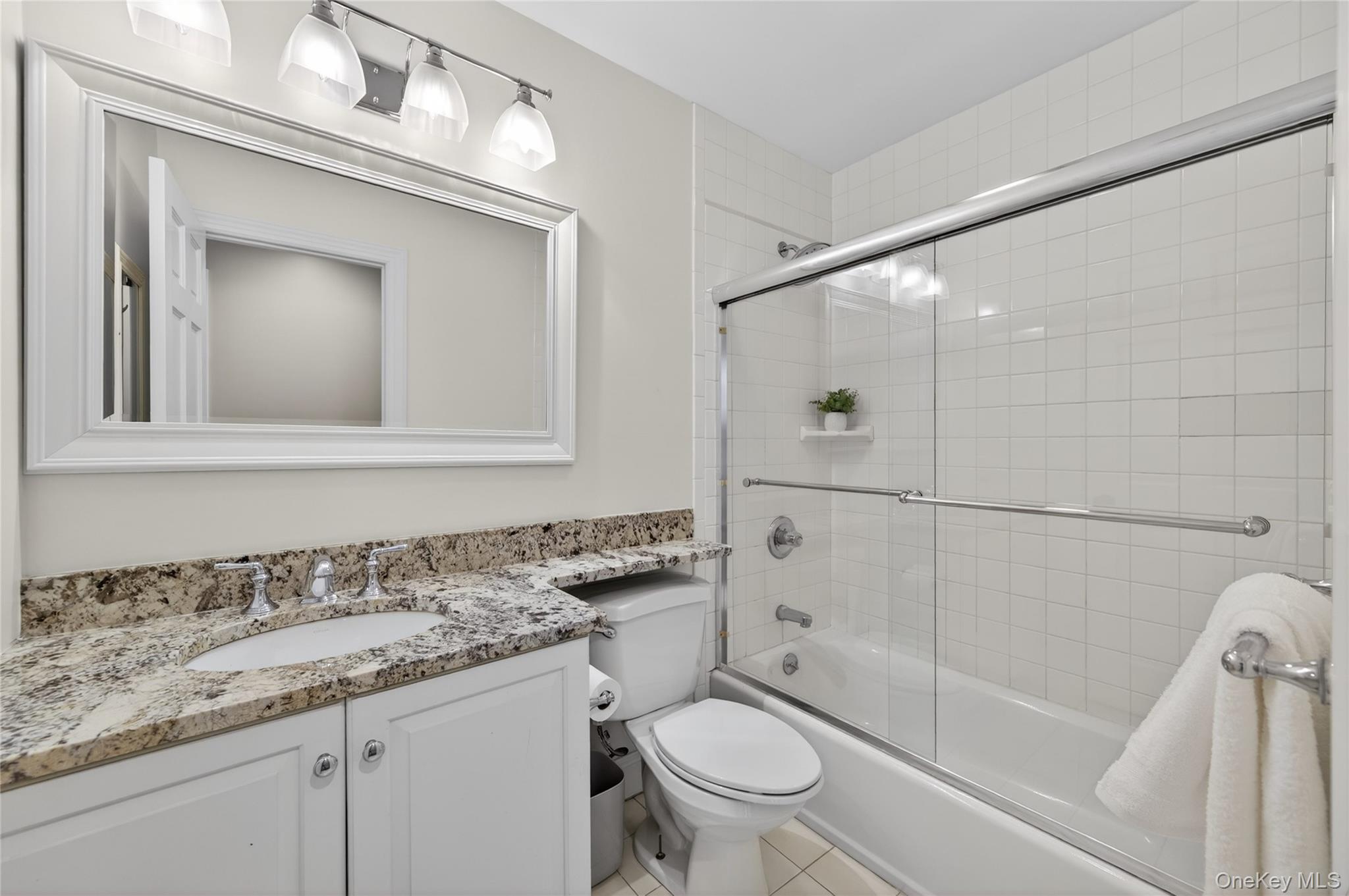 21 Midland Street Cold Spring Harbor, NY 11724 - Photo 28 of 44 a bathroom with a granite countertop sink toilet and shower