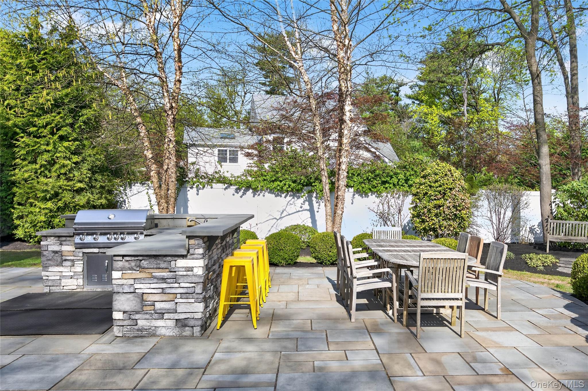 21 Midland Street Cold Spring Harbor, NY 11724 - Photo 37 of 44 a view of a patio with table and chairs and potted plants