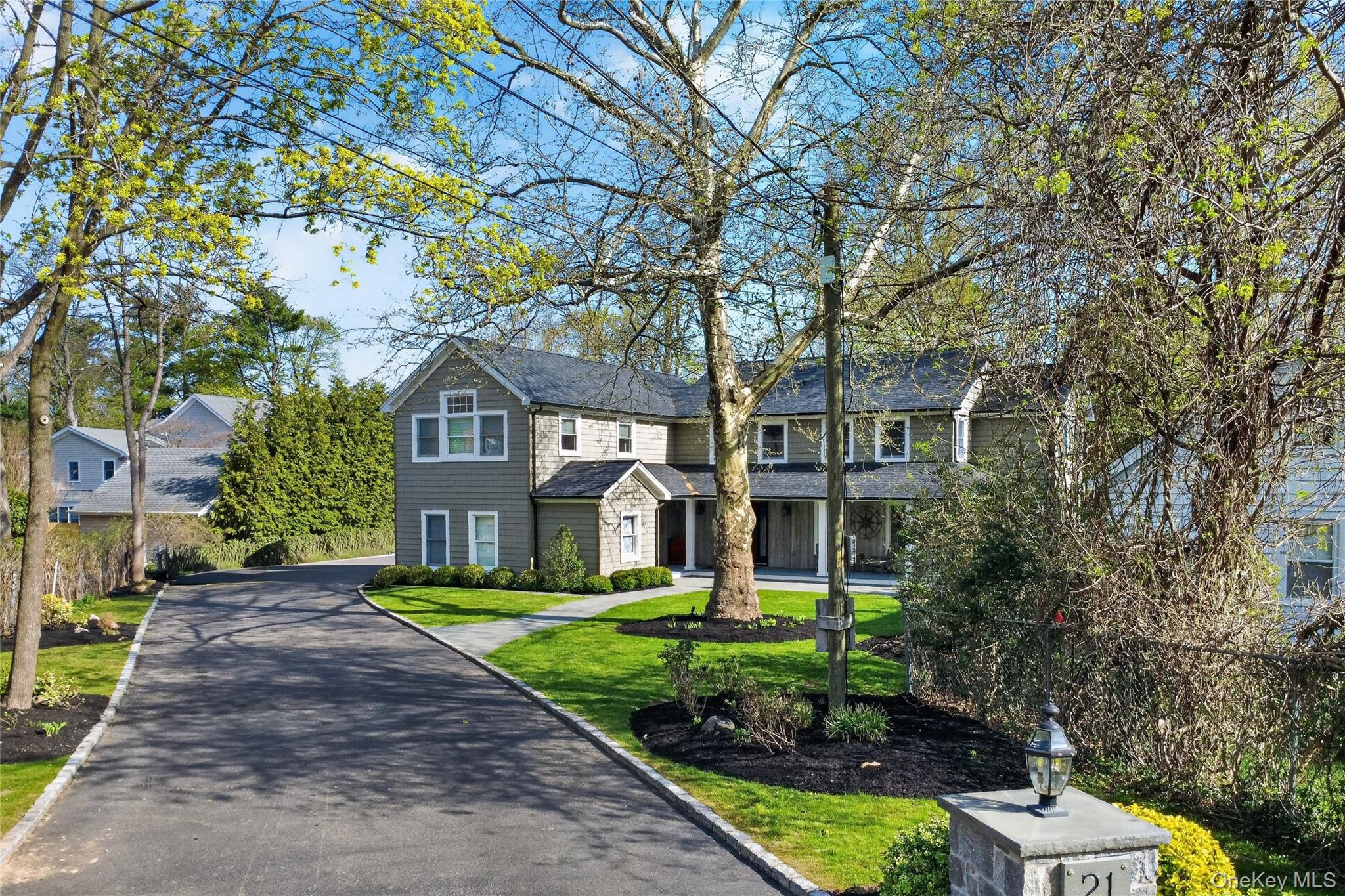21 Midland Street Cold Spring Harbor, NY 11724 - Photo 44 of 44 a front view of a house with a yard and trees