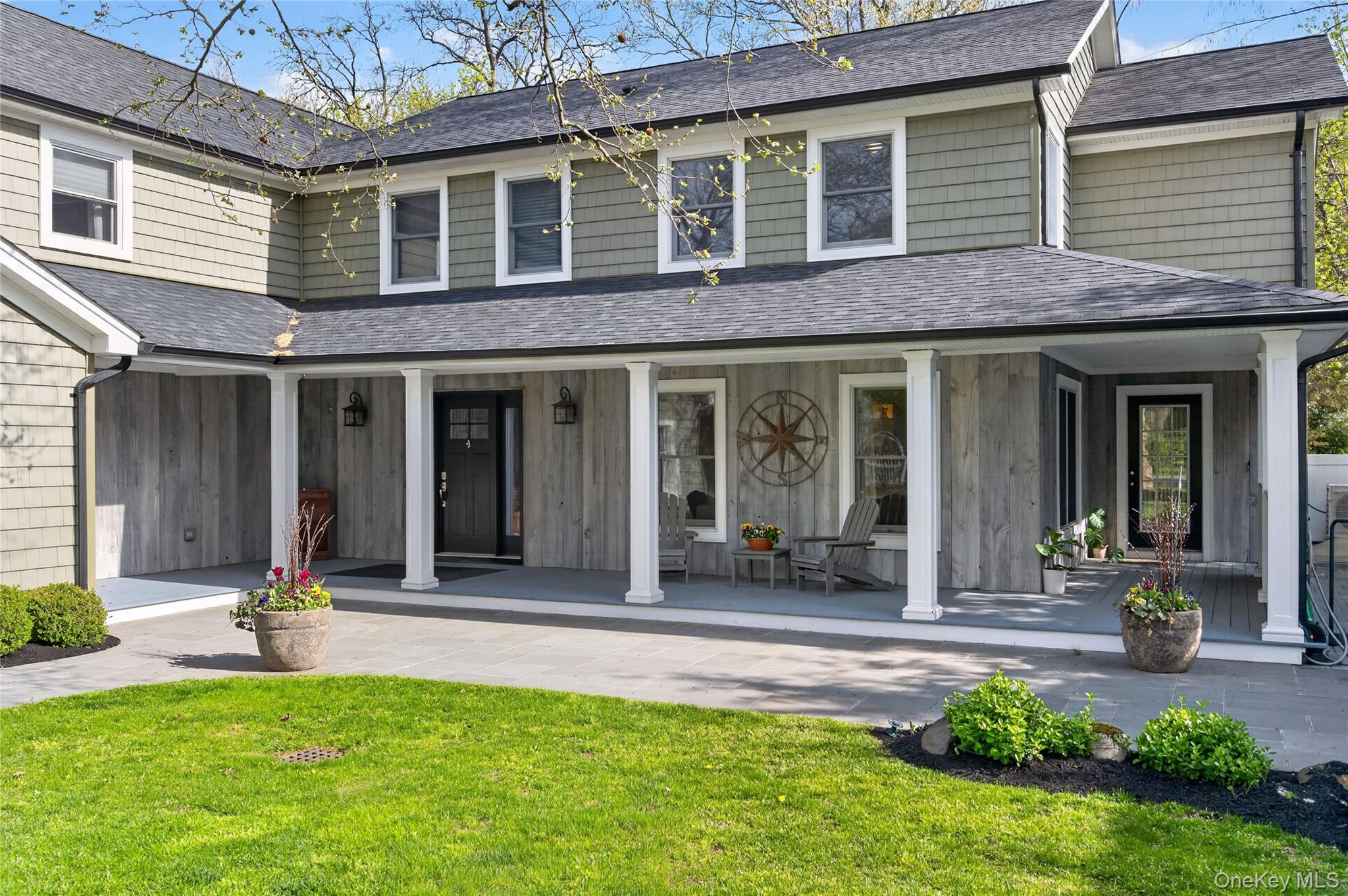21 Midland Street Cold Spring Harbor, NY 11724 - Photo 5 of 44 a front view of a house with a garden and plants