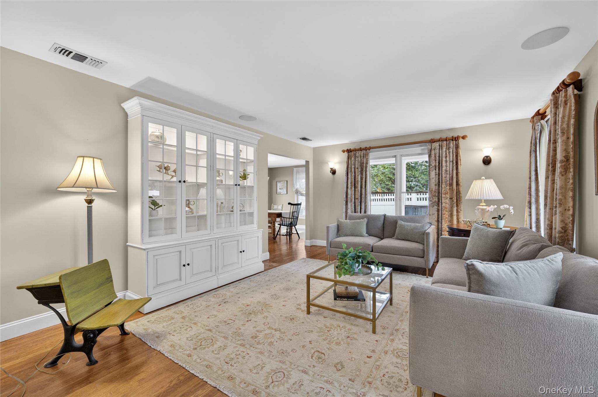 21 Midland Street Cold Spring Harbor, NY 11724 - Photo 8 of 44 a living room with furniture and a lamp next to a window