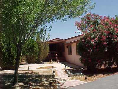 7850 Mojave-Tropico Road Mojave, CA 93501 - Photo 1 of 2 a view of a house with a yard