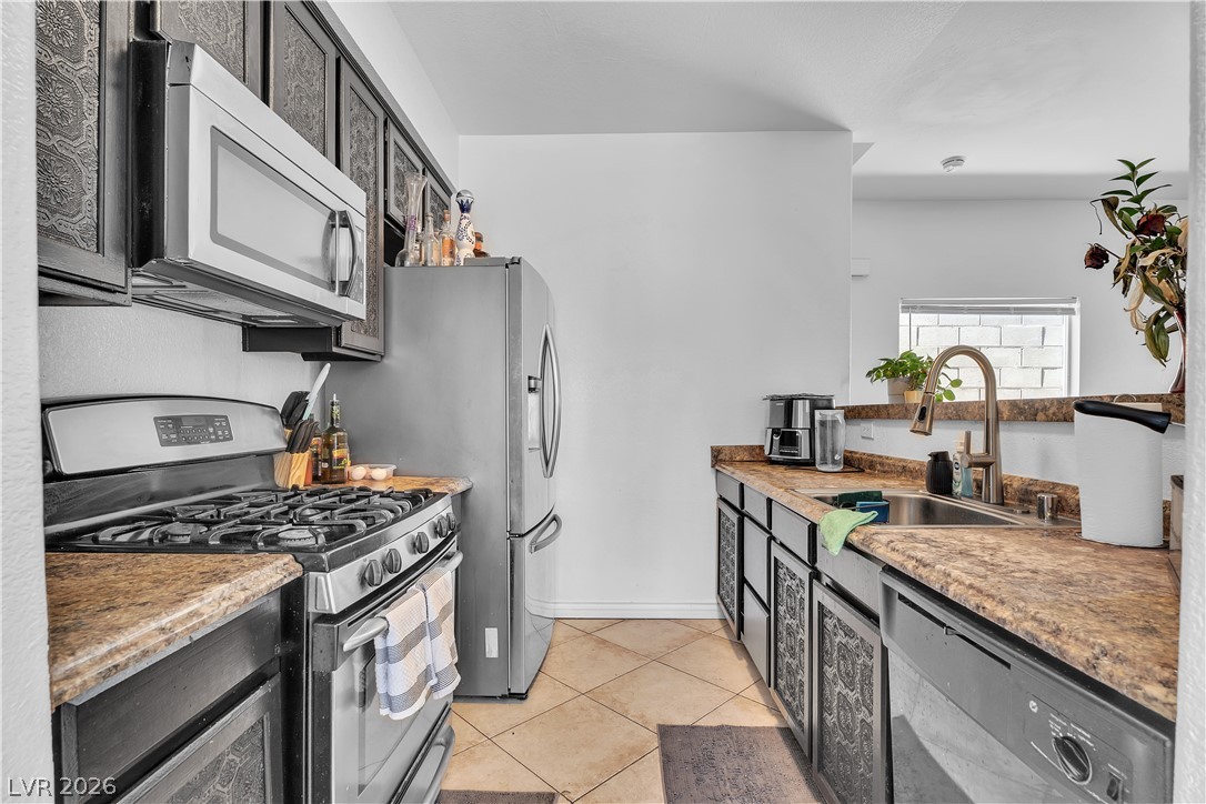 1409 Sycamore Spring Court Las Vegas, NV 89128 - Photo 11 of 28 This functional kitchen features ample counter space and modern appliances for everyday living.