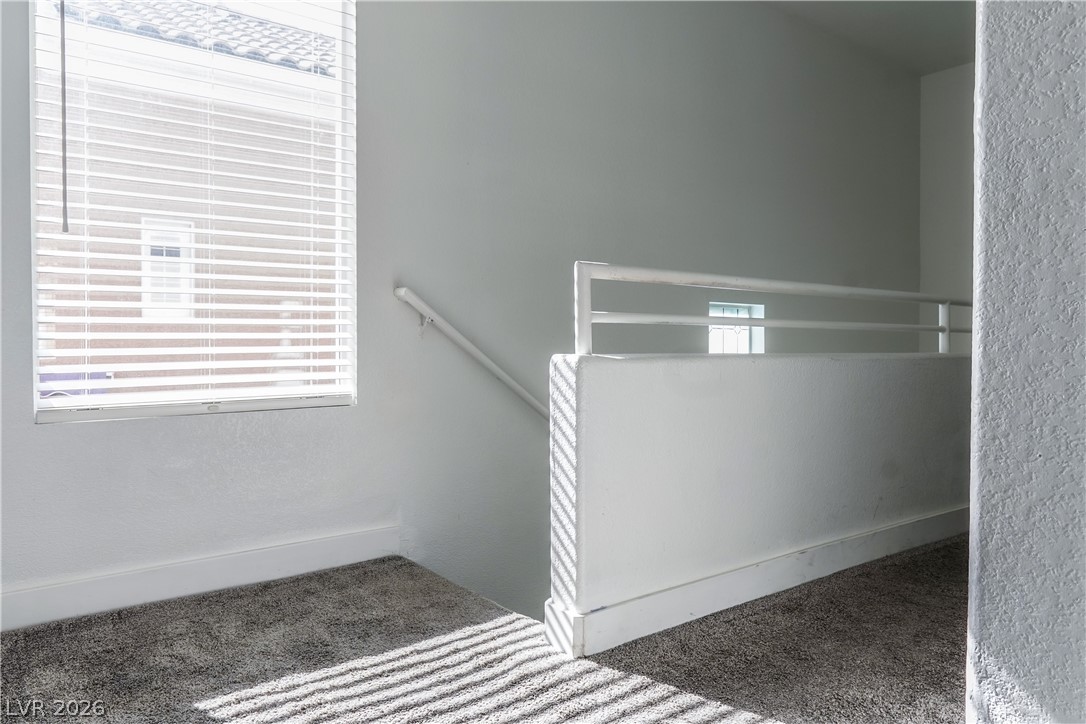 1409 Sycamore Spring Court Las Vegas, NV 89128 - Photo 15 of 28 This interior staircase offers a bright and inviting transition between levels.