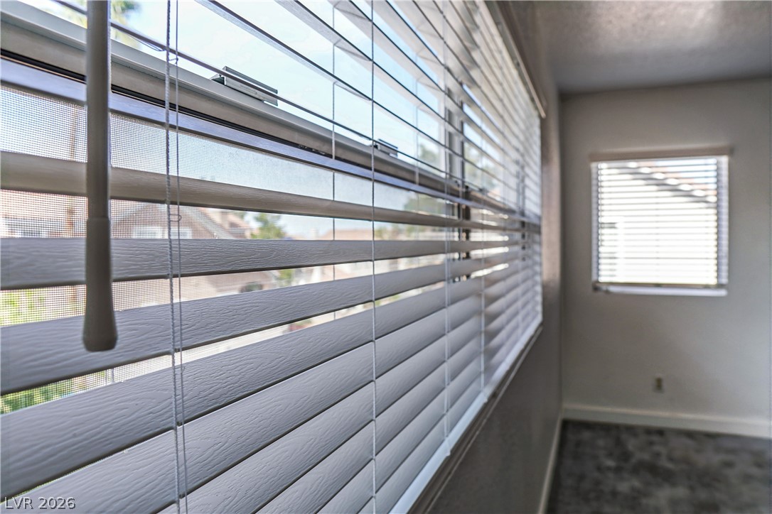 1409 Sycamore Spring Court Las Vegas, NV 89128 - Photo 16 of 28 Natural light streams into this serene space, highlighting textured window treatments.