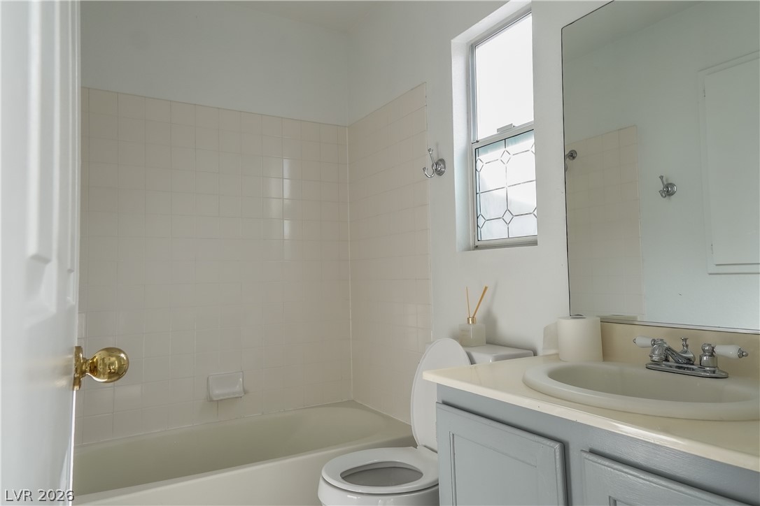 1409 Sycamore Spring Court Las Vegas, NV 89128 - Photo 22 of 28 This bright bathroom features classic tilework and a functional vanity for everyday convenience.