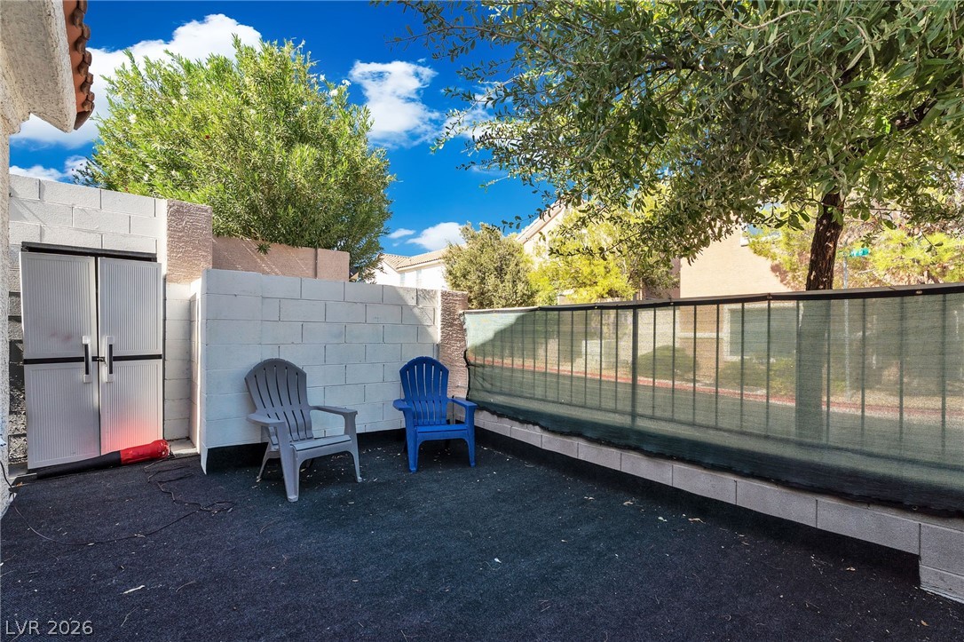 1409 Sycamore Spring Court Las Vegas, NV 89128 - Photo 26 of 28 A private outdoor space features durable fencing and a sturdy storage unit.