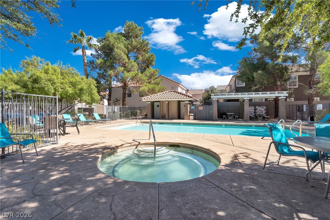 1409 Sycamore Spring Court Las Vegas, NV 89128 - Photo 3 of 28 Relax and unwind in this inviting community oasis, perfect for enjoying sunny days by the water.