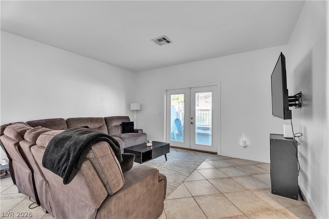 1409 Sycamore Spring Court Las Vegas, NV 89128 - Photo 5 of 28 This bright living space features double doors leading to the outdoors and durable tile flooring throughout.