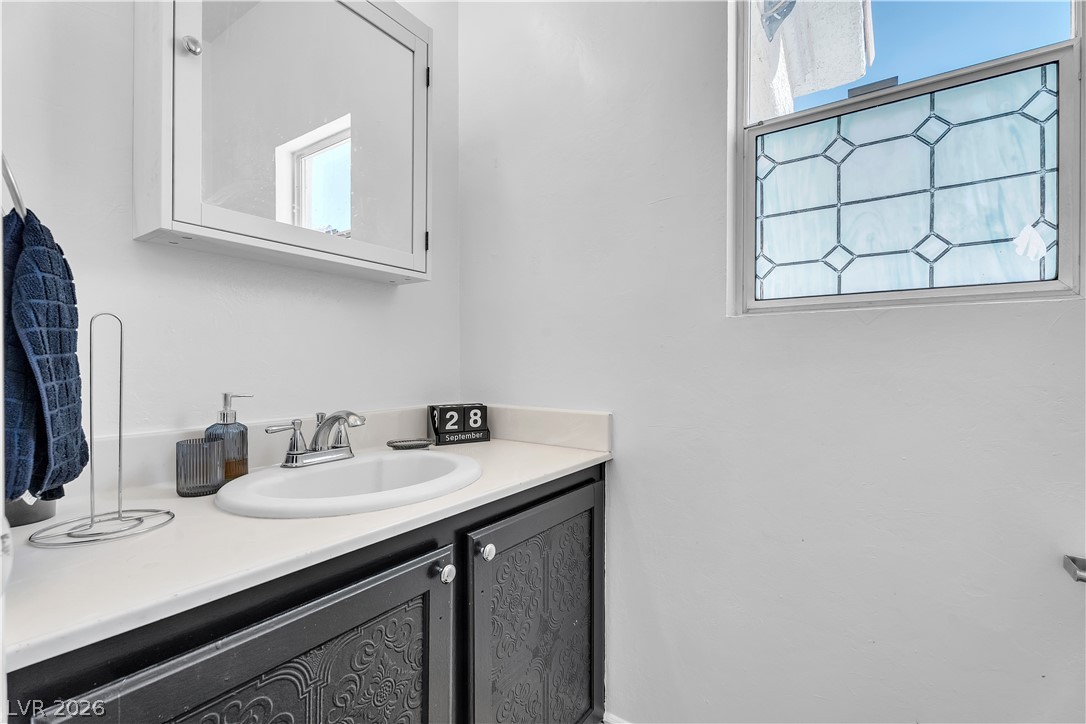1409 Sycamore Spring Court Las Vegas, NV 89128 - Photo 9 of 28 This bathroom features a decorative window, adding charm and brightness to the space.