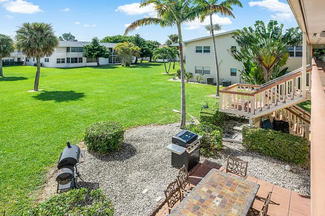 a front view of a house with a yard table and chairs