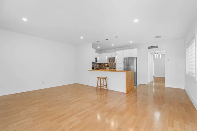 a view of kitchen and kitchen with stainless steel appliances