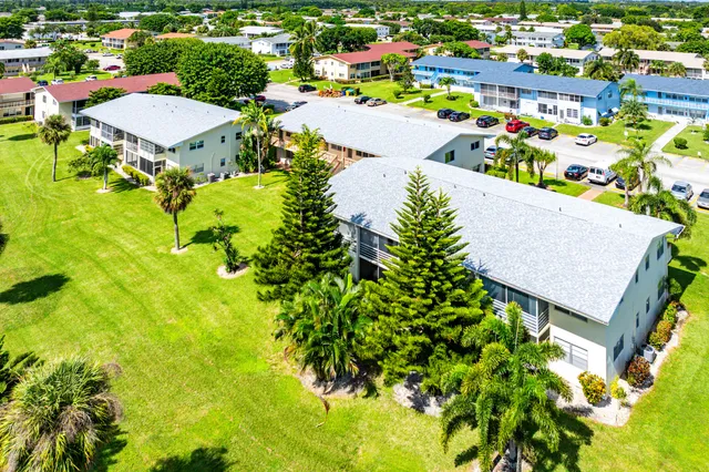 an aerial view of a house with a swimming pool and outdoor seating