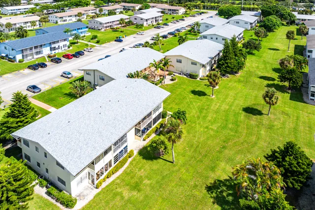 an aerial view of multiple houses with yard