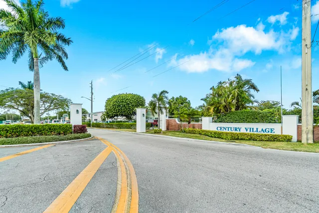 an aerial view of a house with a swimming pool yard and lake view in back