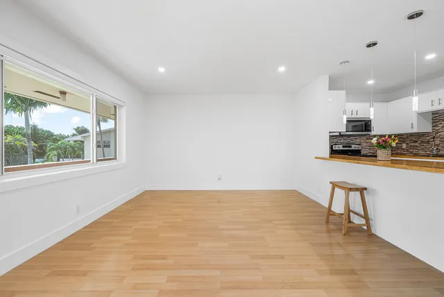 a view of kitchen with window and wooden floor