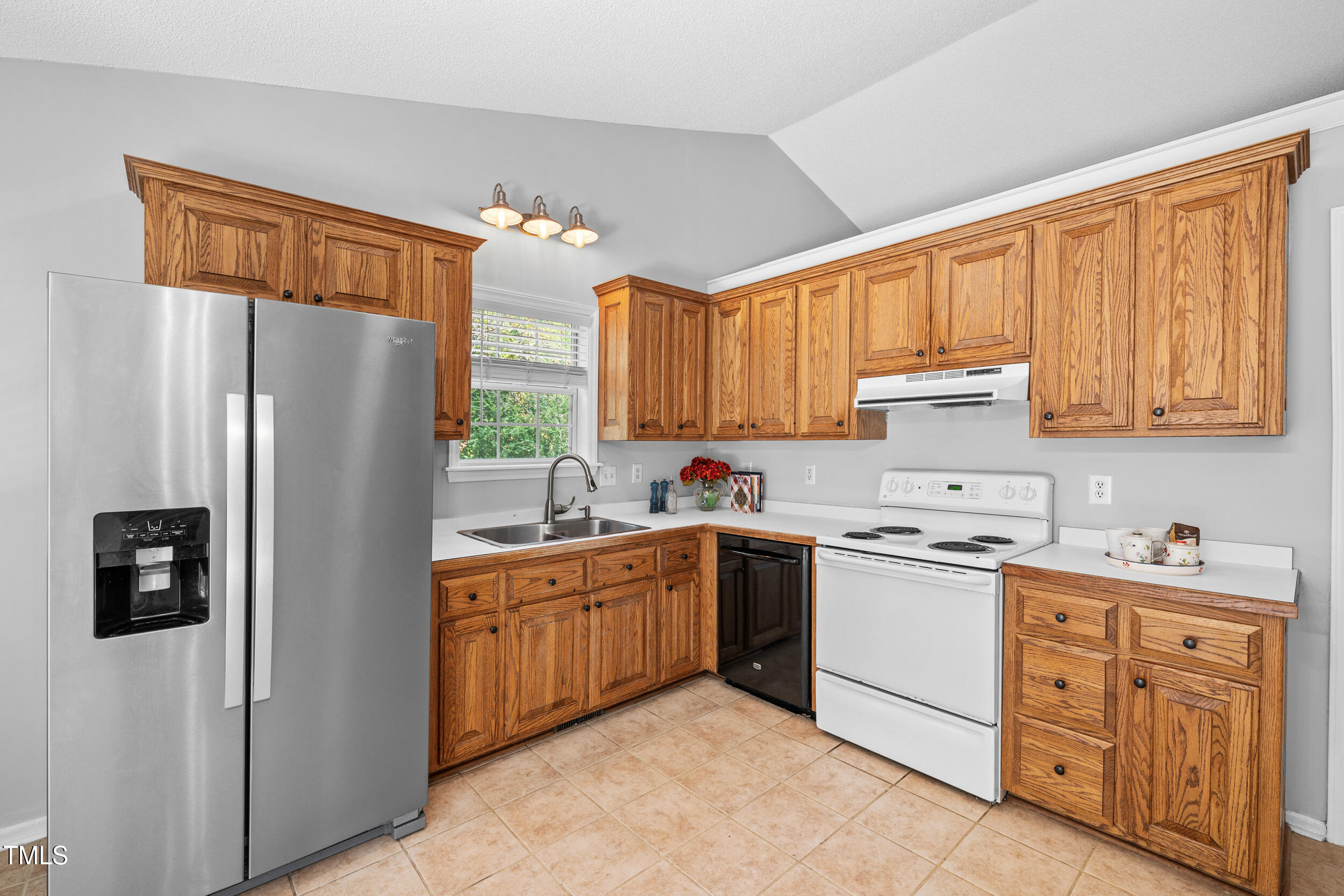 2213 Bufflehead Road Raleigh, NC 27616 - Photo 11 of 30 a kitchen with stainless steel appliances granite countertop a refrigerator sink and cabinets
