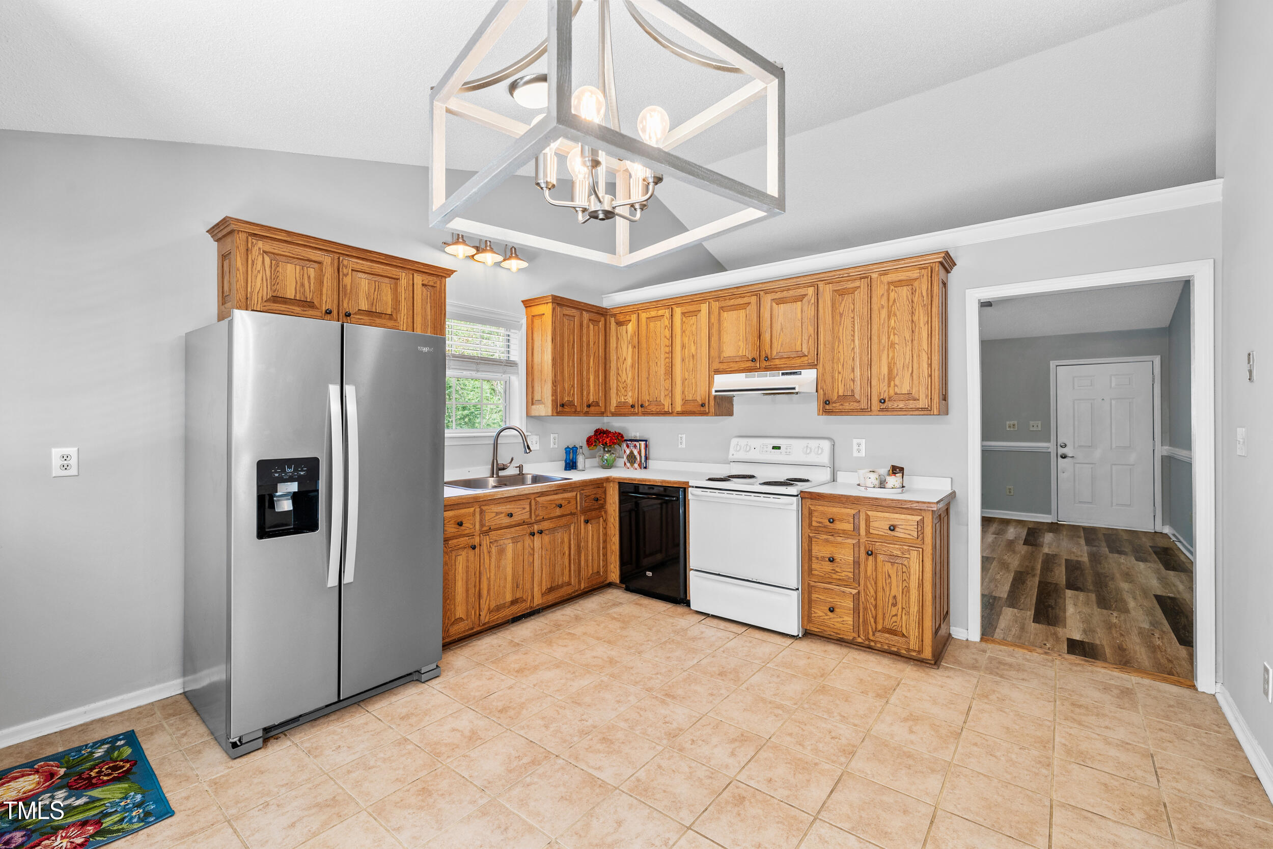 2213 Bufflehead Road Raleigh, NC 27616 - Photo 13 of 30 a kitchen with stainless steel appliances granite countertop a refrigerator a sink dishwasher a stove with wooden cabinets and floor