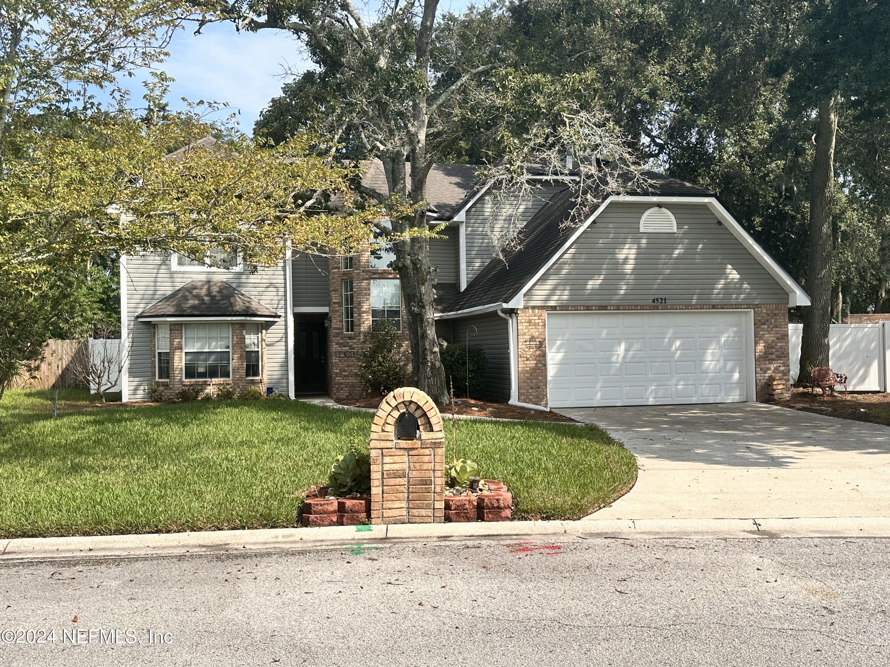 4521 Trevi Drive Jacksonville, FL 32257 - Photo 1 of 24 a front view of a house with a yard