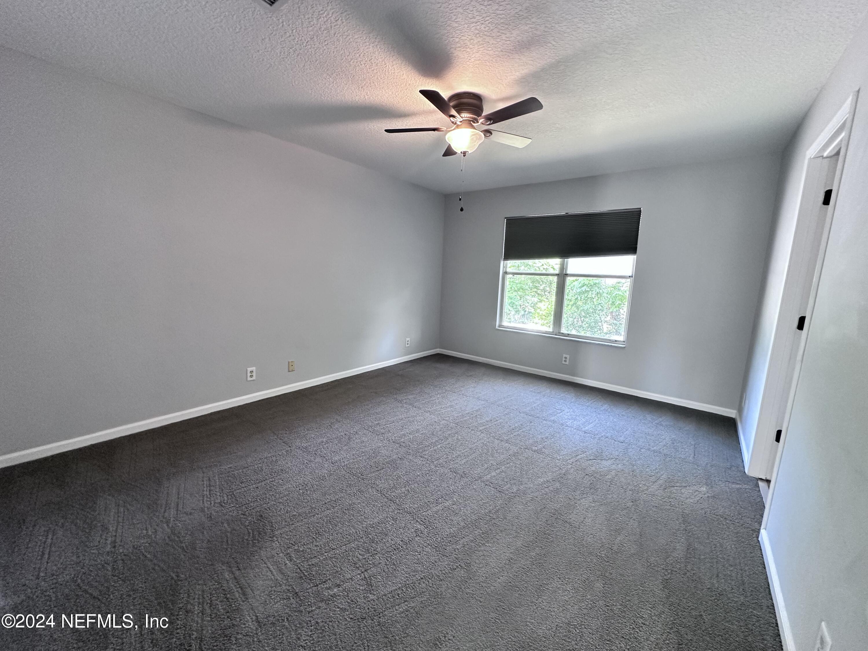 4521 Trevi Drive Jacksonville, FL 32257 - Photo 12 of 24 an empty room with a window and a fan