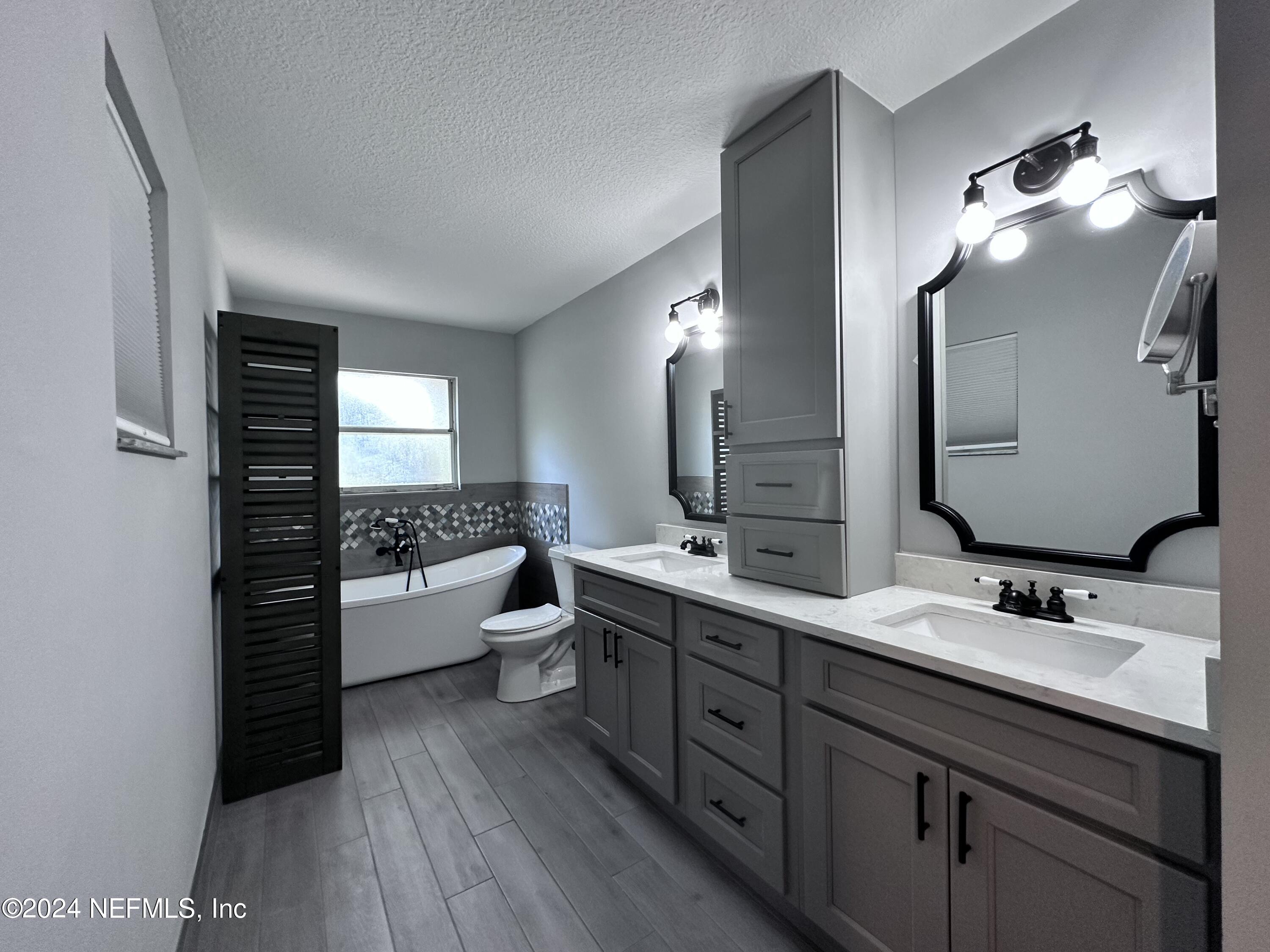 4521 Trevi Drive Jacksonville, FL 32257 - Photo 14 of 24 a bathroom with a double vanity sink and mirror with shower