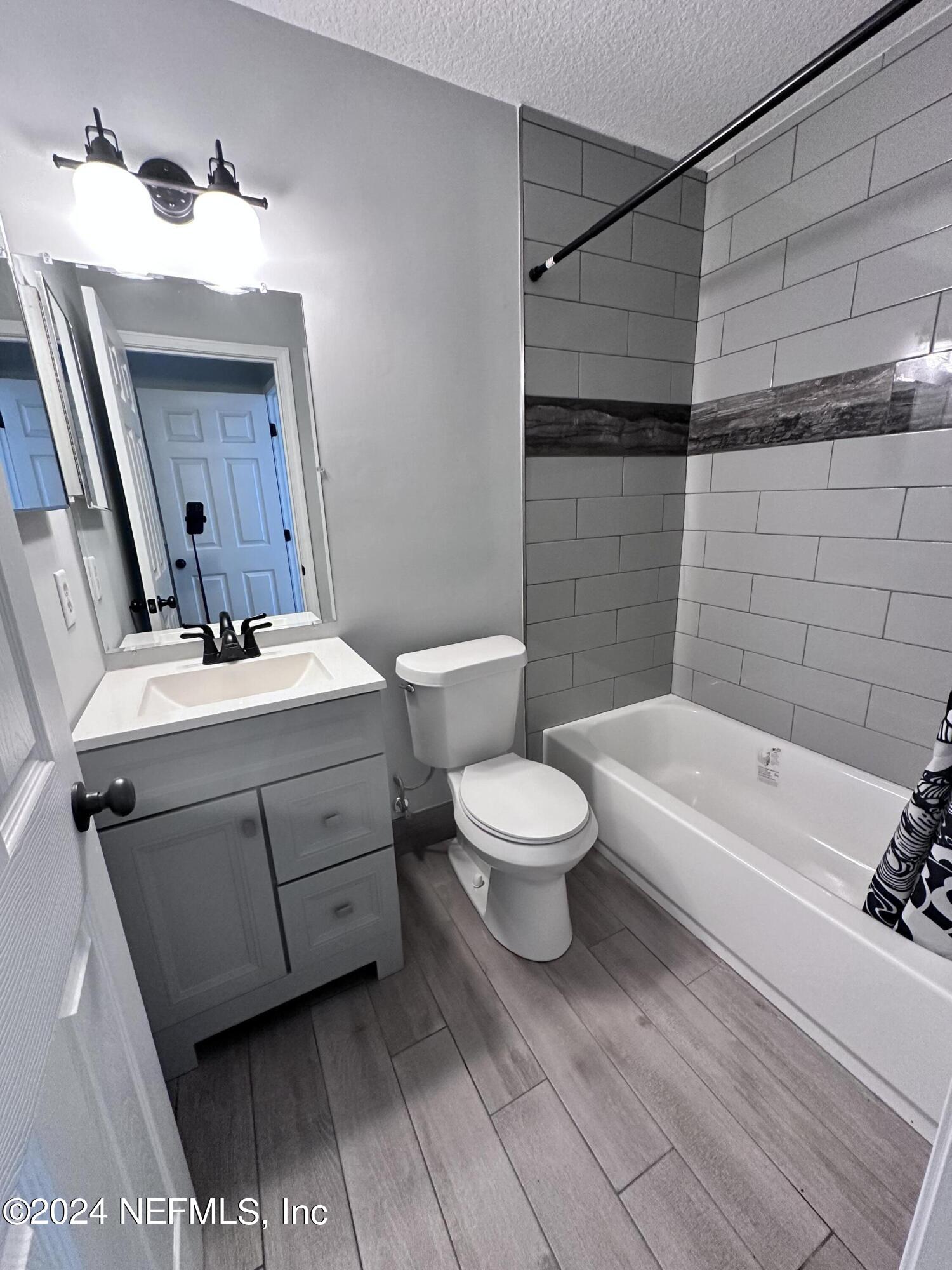 4521 Trevi Drive Jacksonville, FL 32257 - Photo 18 of 24 a bathroom with a white toilet sitting next to a bathroom sink and a shower