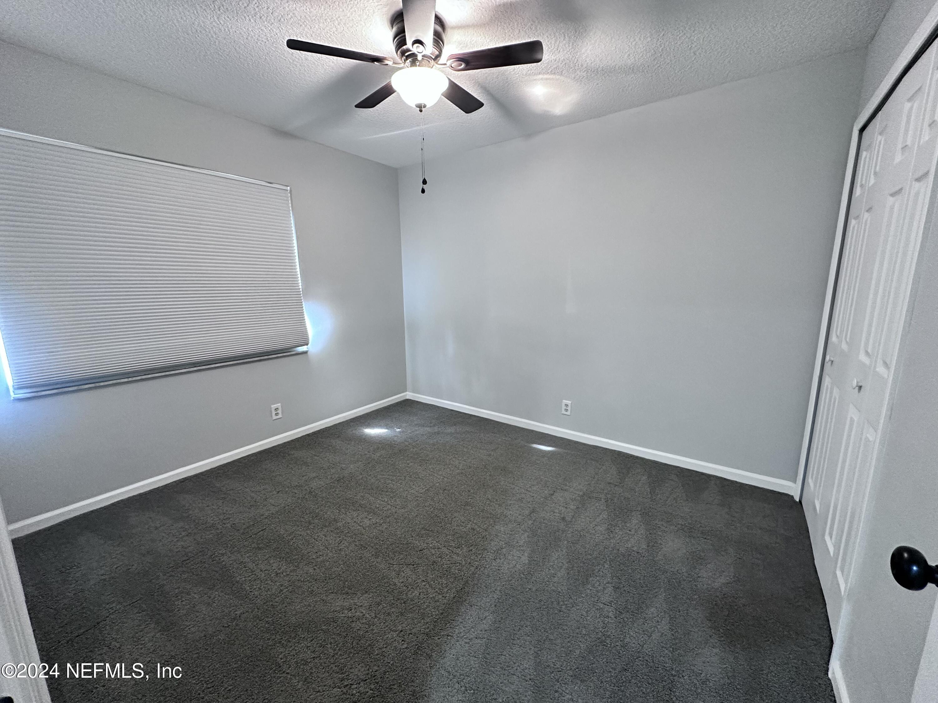 4521 Trevi Drive Jacksonville, FL 32257 - Photo 19 of 24 an empty room with a ceiling fan and a window