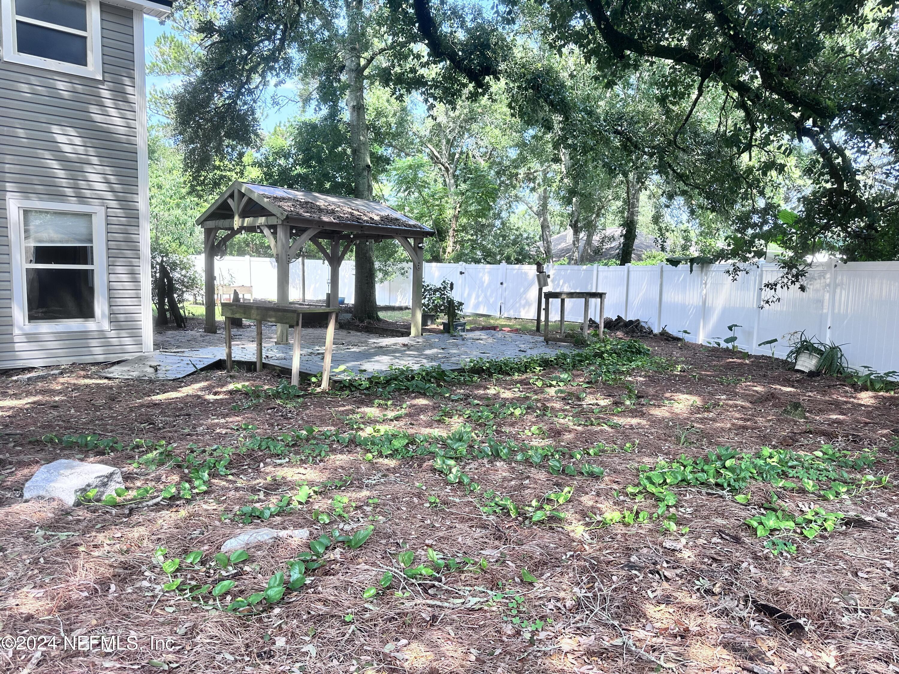 4521 Trevi Drive Jacksonville, FL 32257 - Photo 22 of 24 a backyard of a house with table and chairs