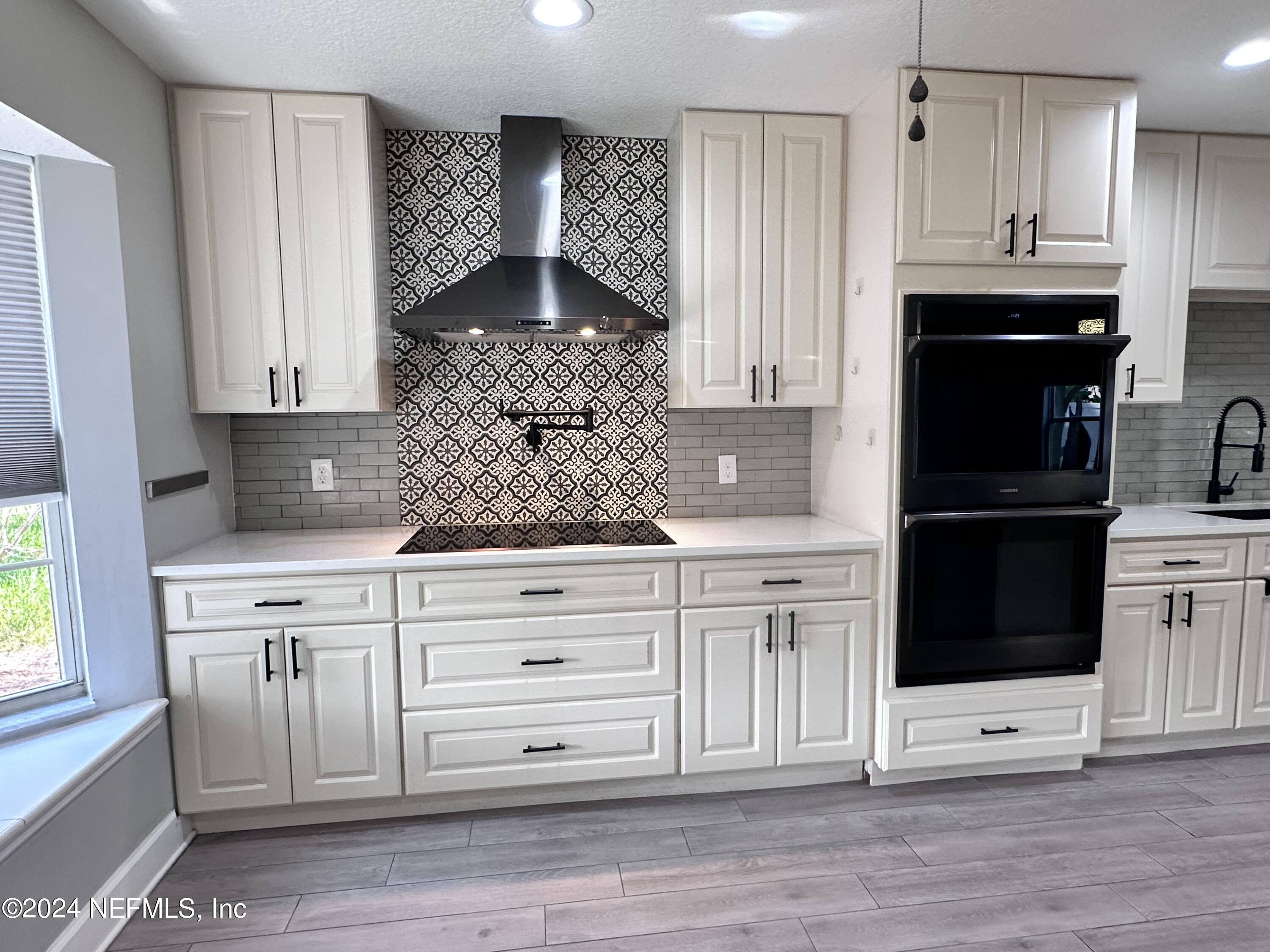 4521 Trevi Drive Jacksonville, FL 32257 - Photo 5 of 24 a kitchen with stainless steel appliances white cabinets and a refrigerator