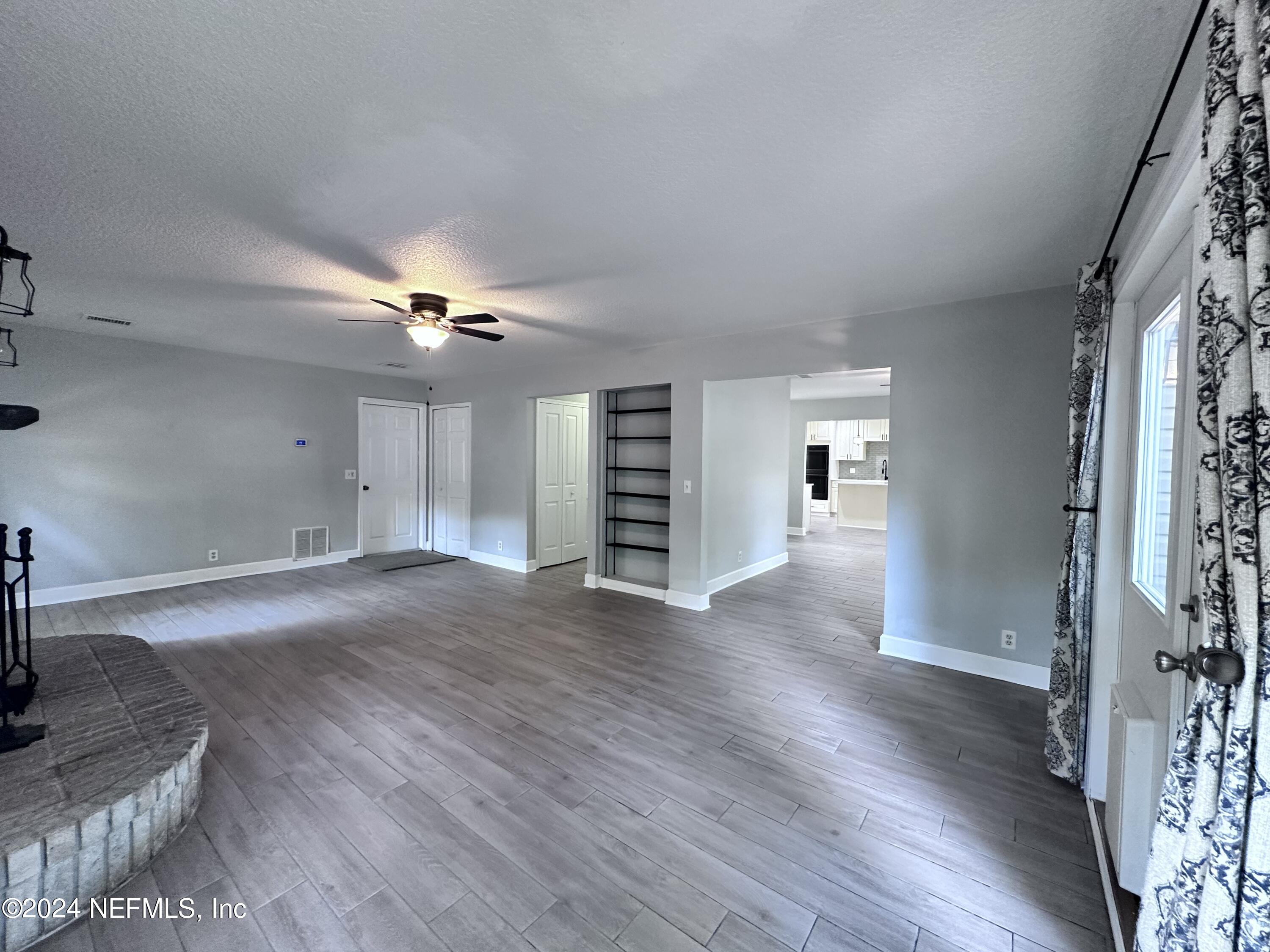 4521 Trevi Drive Jacksonville, FL 32257 - Photo 9 of 24 a view of a livingroom with wooden floor and staircase