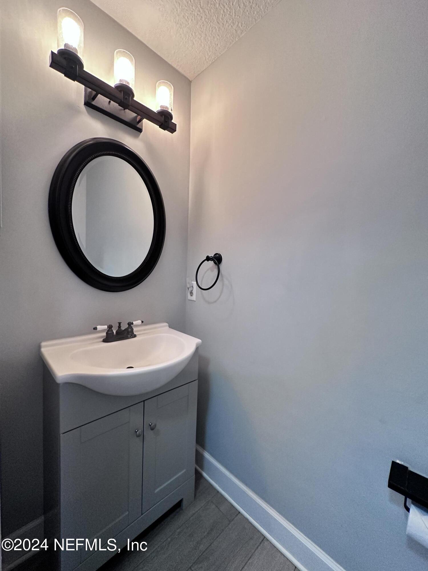 4521 Trevi Drive Jacksonville, FL 32257 - Photo 10 of 24 a bathroom with a toilet a sink and a mirror