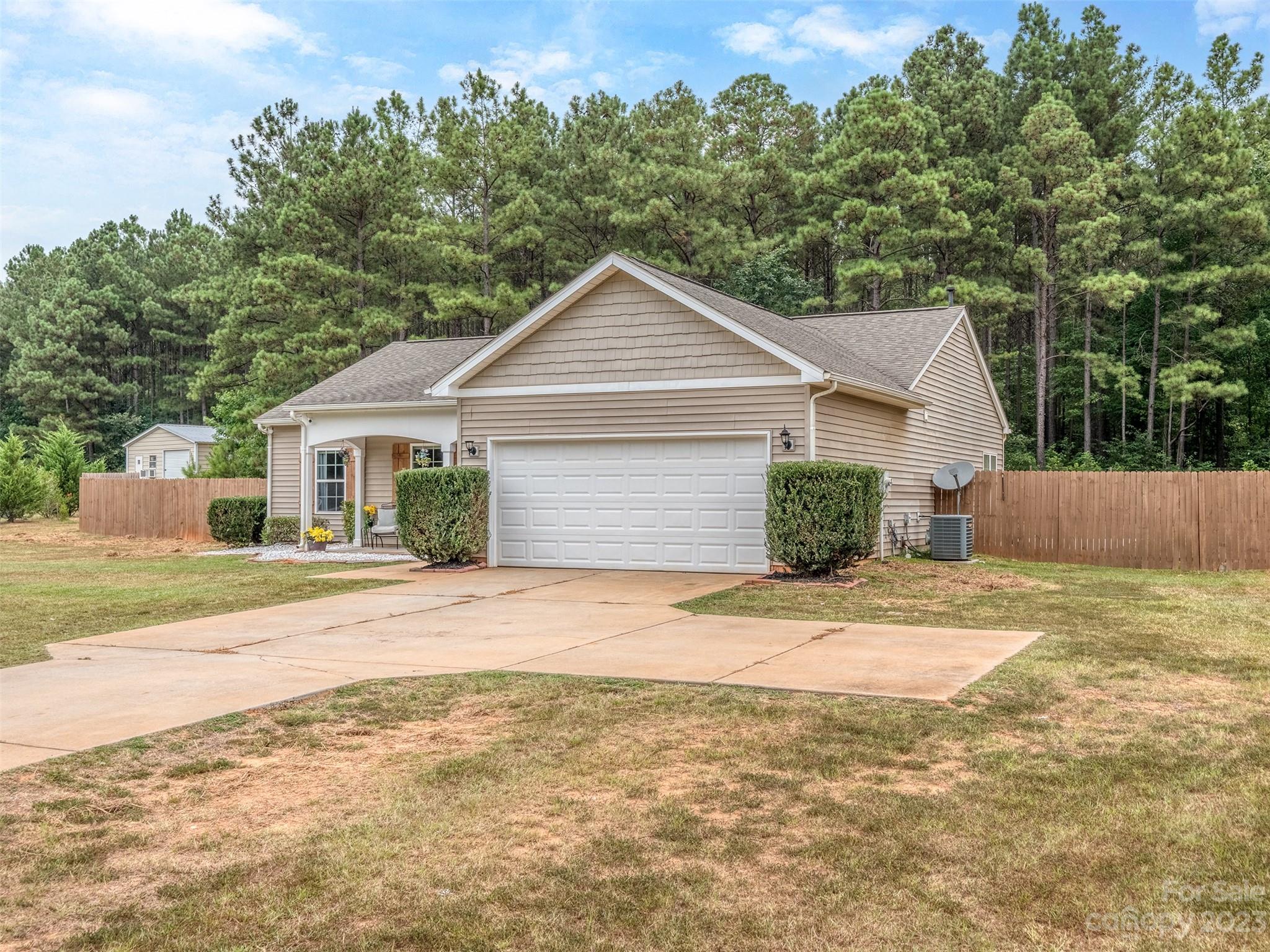 1051 Duckwood Road Lancaster, SC 29720 - Photo 2 of 18 a front view of a house with a yard and garage