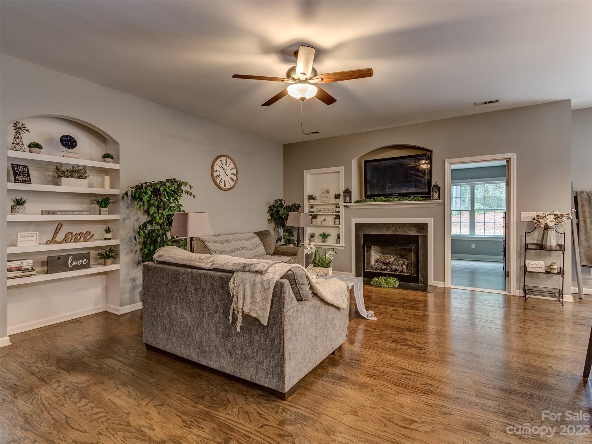 1051 Duckwood Road Lancaster, SC 29720 - Photo 3 of 18 a living room with furniture a fireplace and a flat screen tv