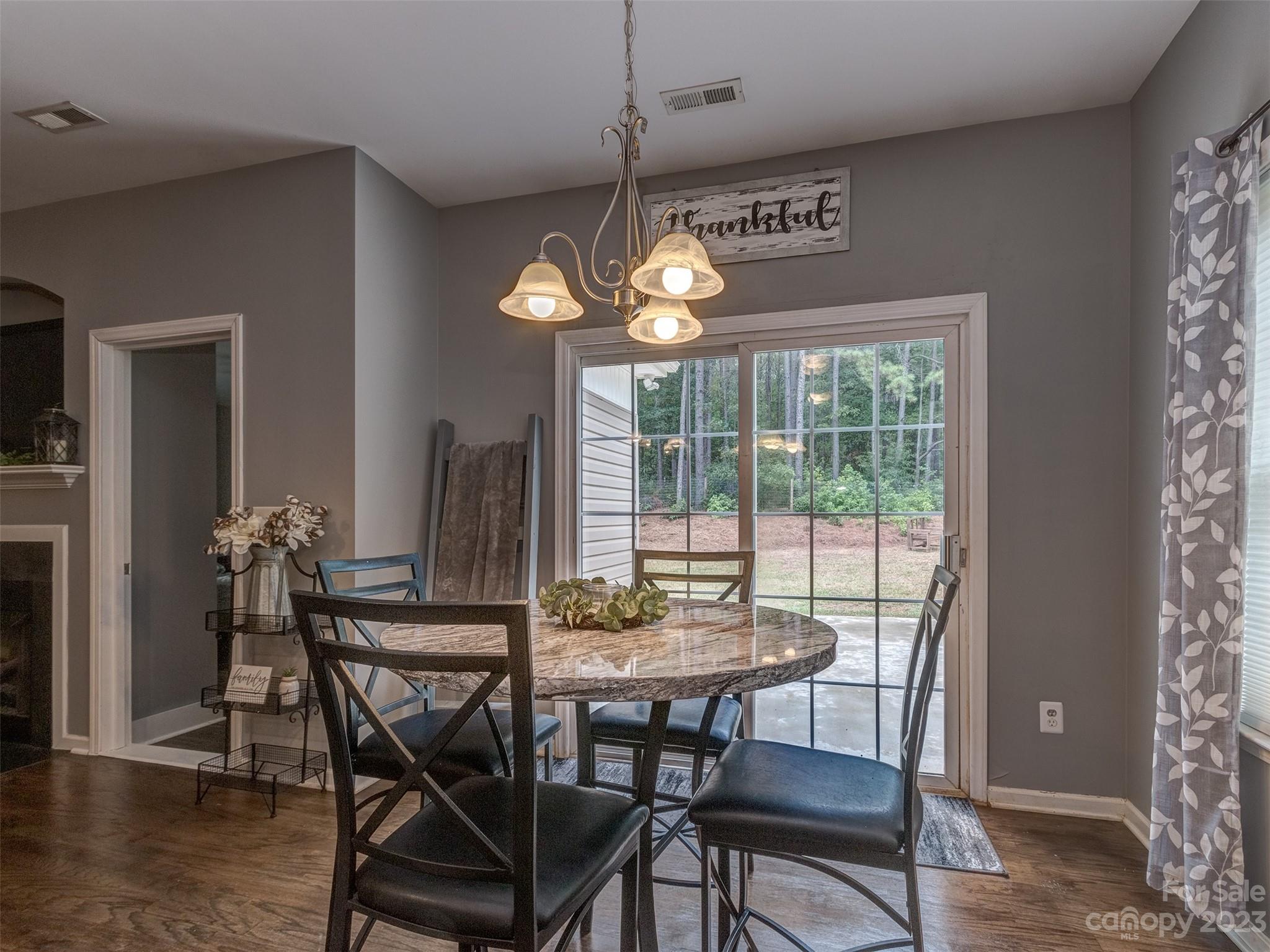 1051 Duckwood Road Lancaster, SC 29720 - Photo 8 of 18 a dining room with furniture a chandelier and wooden floor