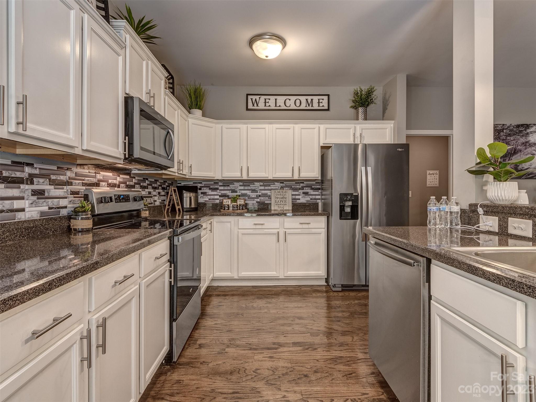 1051 Duckwood Road Lancaster, SC 29720 - Photo 9 of 18 a kitchen with white cabinets and stainless steel appliances