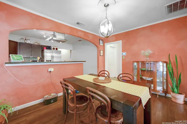 a view of a dining room with furniture and a chandelier
