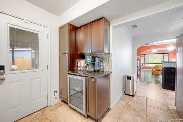 a kitchen with stainless steel appliances granite countertop a refrigerator and a stove