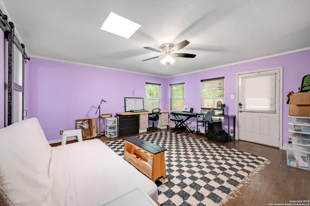 a living room with furniture a chandelier and a dining table with wooden floor