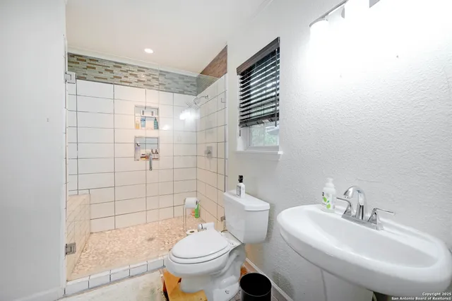 a bathroom with a sink toilet and shower