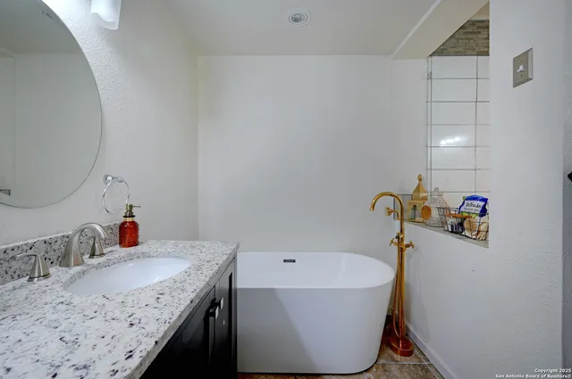a bath tub sitting next to a bathroom sink