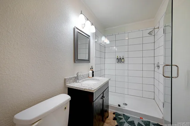 a bathroom with a sink toilet and shower