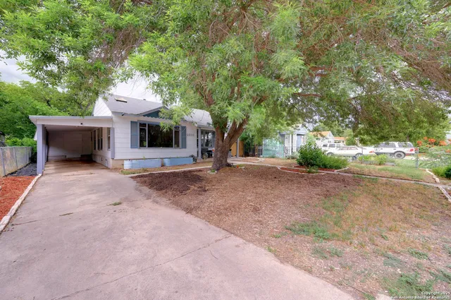 a view of a house with a yard and garage