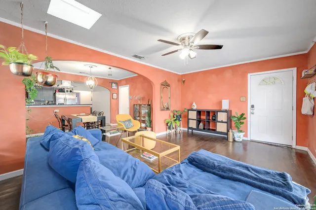 a living room with furniture and wooden floor