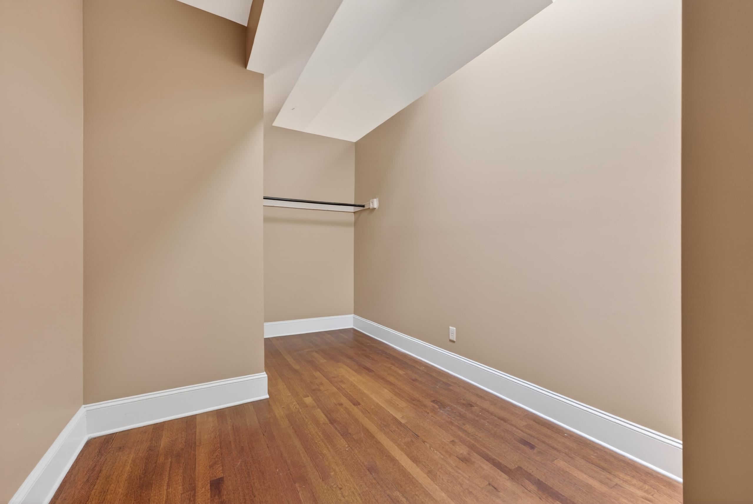 530 West Raines Road Memphis, TN 38109 - Photo 35 of 38 Wardrobe space featuring wood-finish flooring, neutral wall tones, and white baseboards