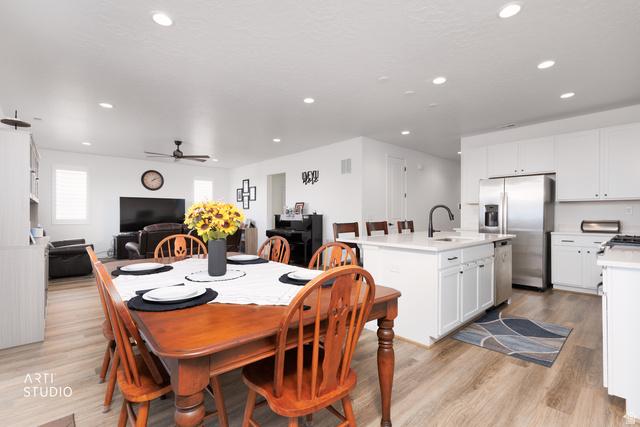 540 Lefty Lane Tooele, UT 84074 - Photo 9 of 48 Dining space featuring light wood-style floors, recessed lighting, and a ceiling fan