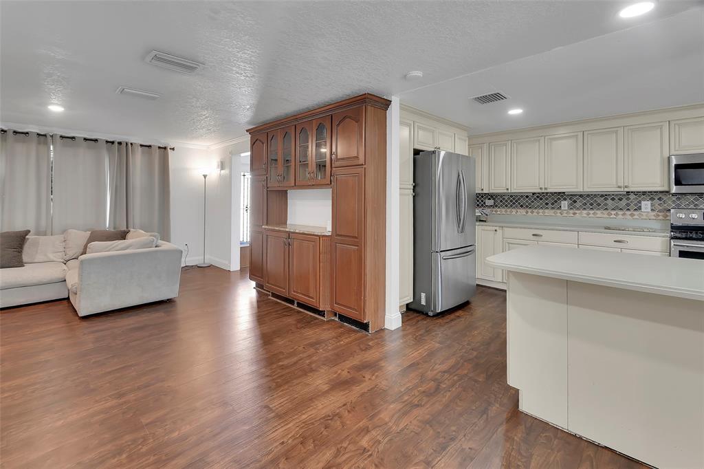 115 Juan Road DeBary, FL 32713 - Photo 11 of 41 a open kitchen with stainless steel appliances granite countertop a refrigerator sink and white cabinets