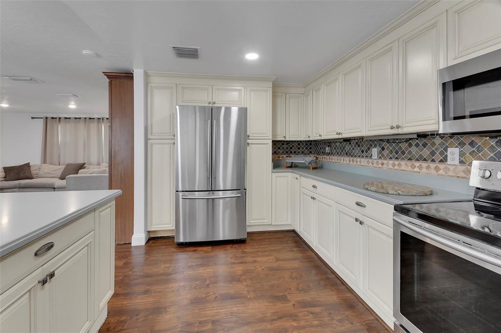 115 Juan Road DeBary, FL 32713 - Photo 14 of 41 a kitchen with a sink a stove a refrigerator and cabinets