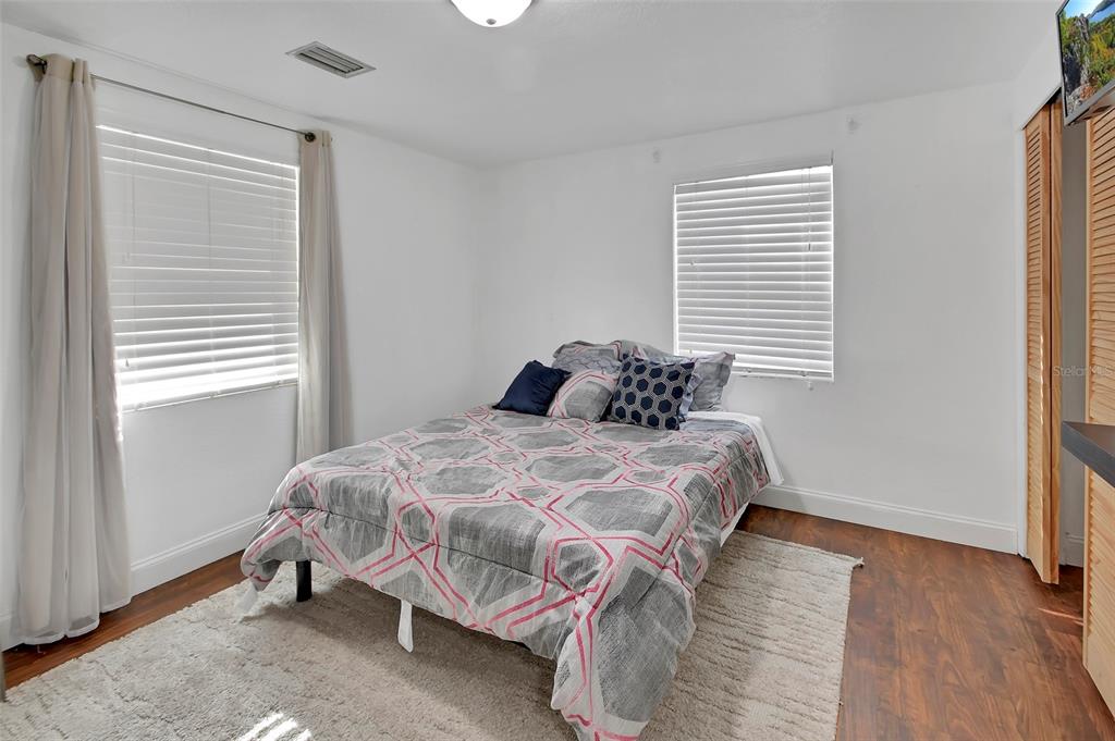 115 Juan Road DeBary, FL 32713 - Photo 18 of 41 a bedroom with a bed and wooden floor