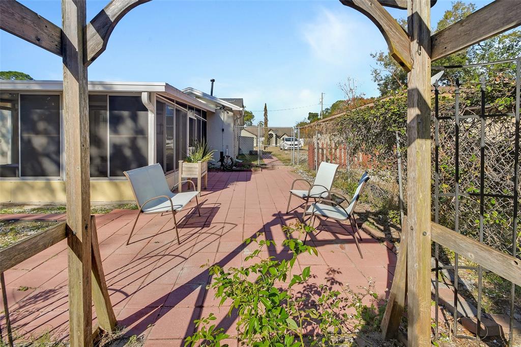 115 Juan Road DeBary, FL 32713 - Photo 32 of 41 a view of a patio with table and chairs and potted plants