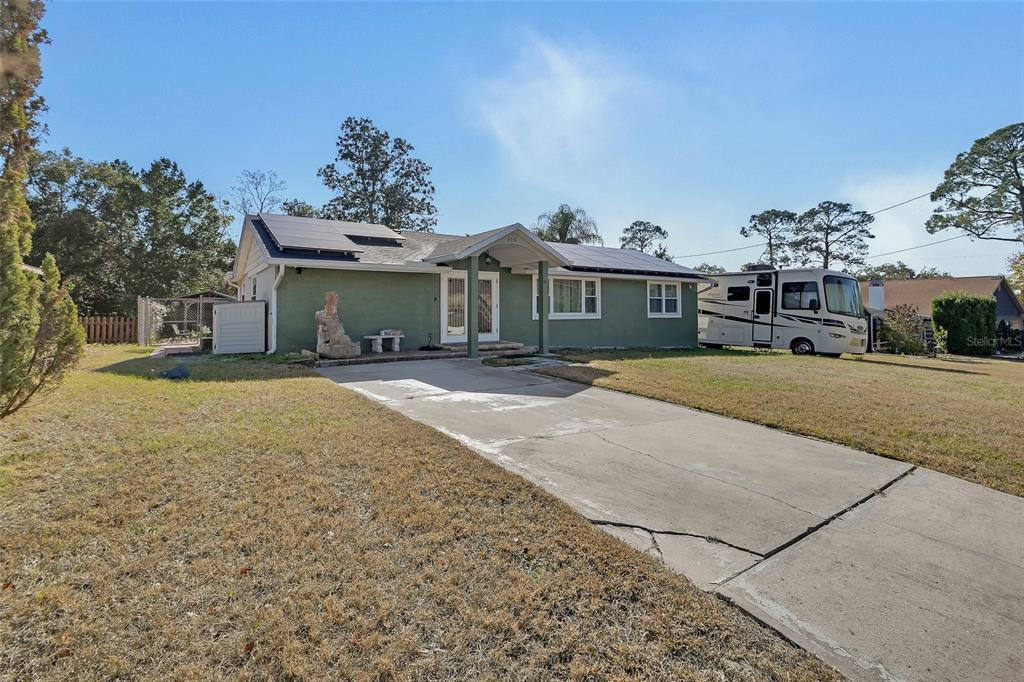 115 Juan Road DeBary, FL 32713 - Photo 39 of 41 a front view of a house with a yard and garage